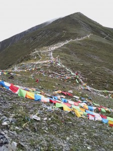 Tibetan prayer flags top of mountain peak
