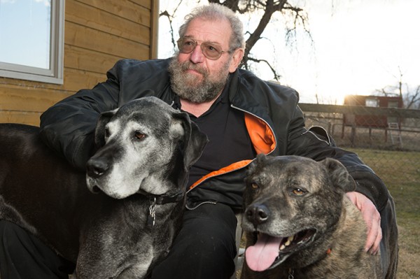 Rollin relaxes at home with his dogs, Molly and King. Photo by Bill Cotton.