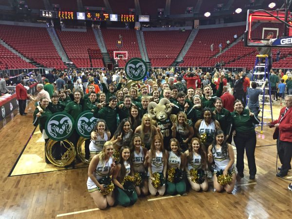 The band and Golden Poms celebrate the women's win