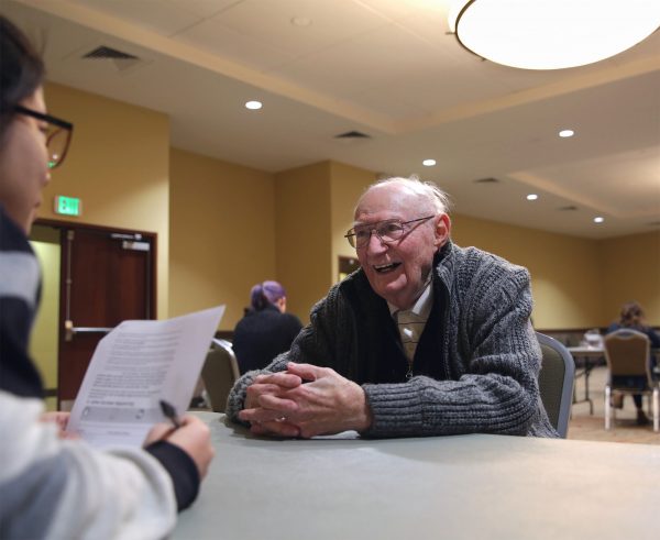 Kyu Rim Kang, a doctoral student in occupation and rehabilitation science at Colorado State University, administers a test to B Sharp participant Hal Squier before the Fort Collins Symphony concert on Saturday, Feb. 6, 2016. (Corey H. Jones/CPR News)