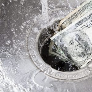 Cash being flushed down a kitchen sink drain