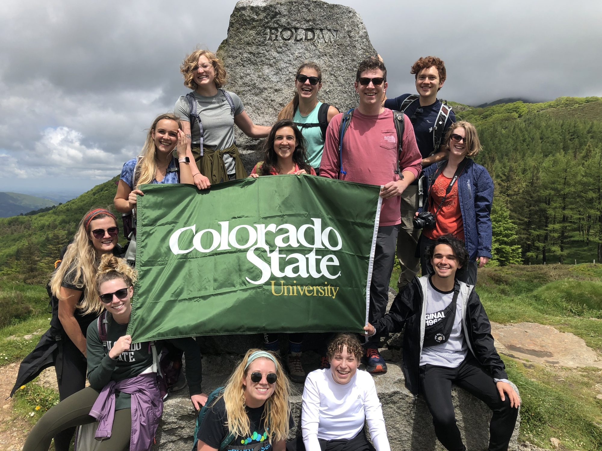 Students holding a Colorado State University flag along the Camino de Santiago