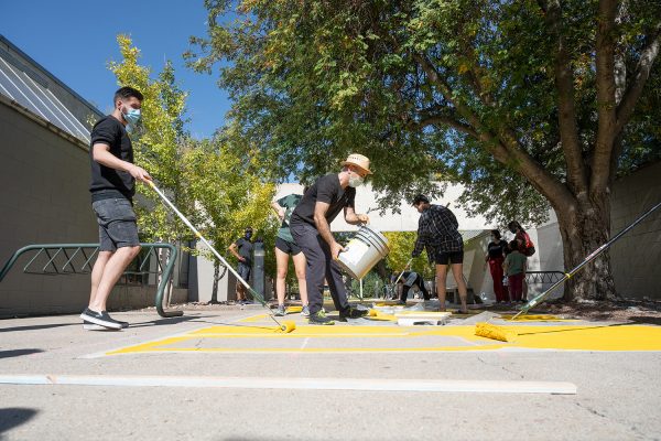 Faculty and students in a collaborative between Art, Ethnic Studies, and the Black/African American Culture Center, paint "Black Lives Matter" on the sidewalk outside the Art Building, October 10, 2020