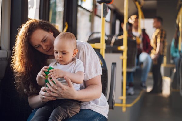 Woman carrying her child on a public bus