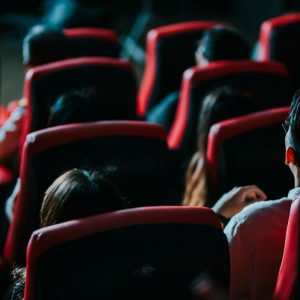 Rear view of an Asian audience watching a movie in cinema