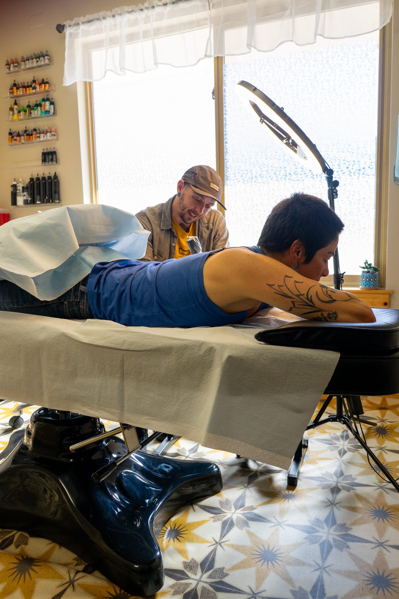 Cei Lambert tattoos on his client Lauren's arm