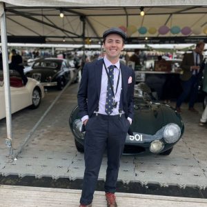 Justin Smith poses in front of an English car at a festival in West Sussex, England