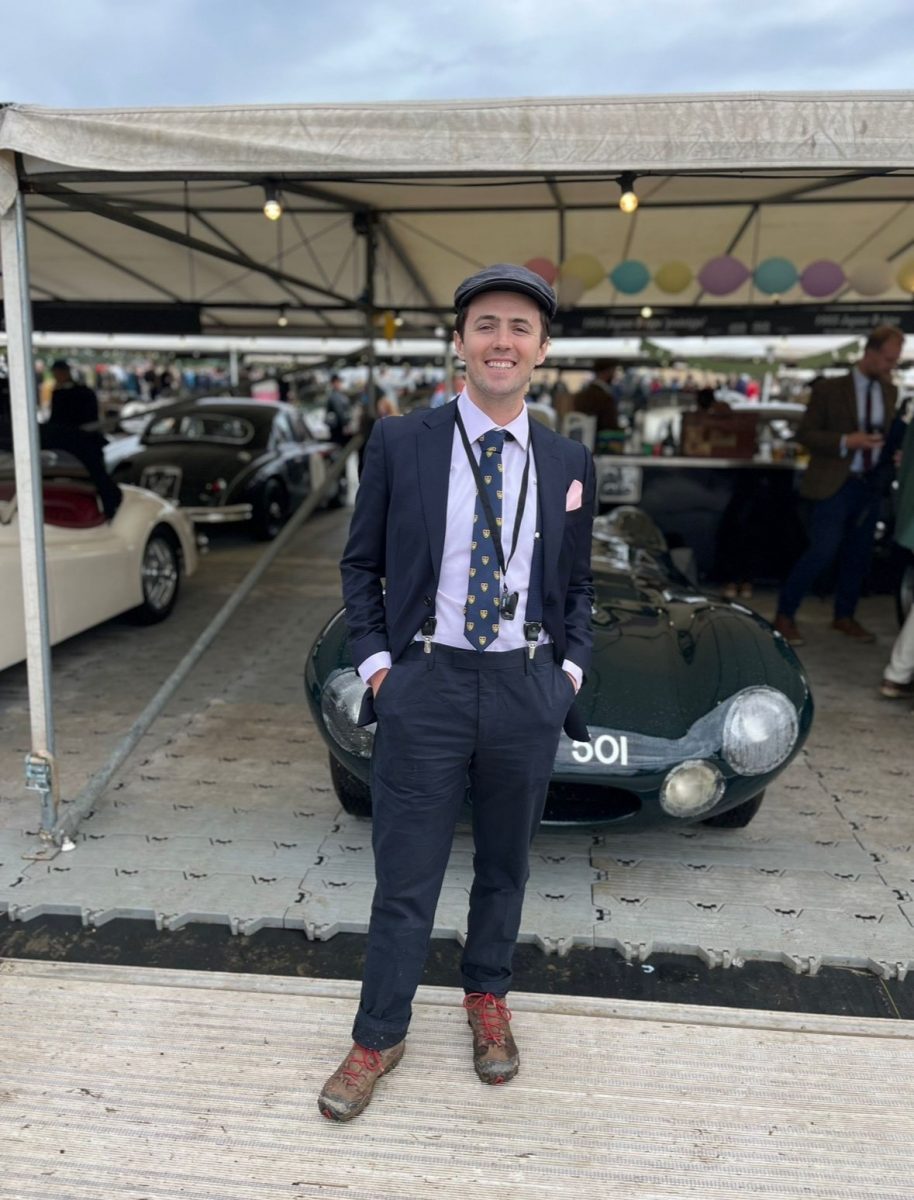 Justin Smith poses in front of an English car at a festival in West Sussex, England