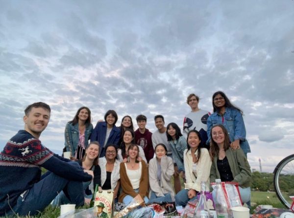 Justin Smith takes group photo with friends from his master's program in the UK