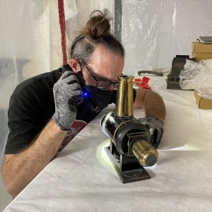 Jerry Smith inspects an object at the Lucas Museum’s storage facility