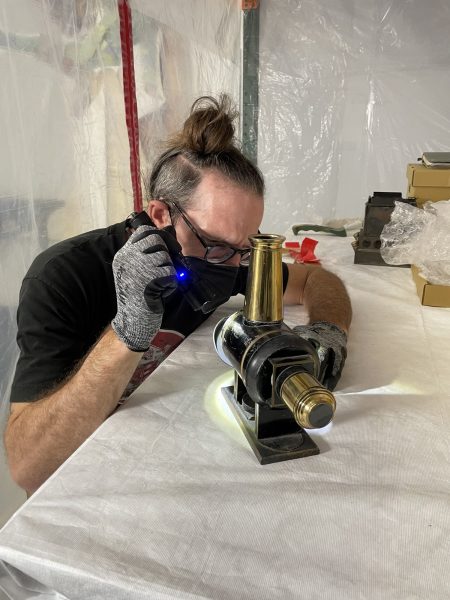 Jerry Smith inspects an object at the Lucas Museum’s storage facility