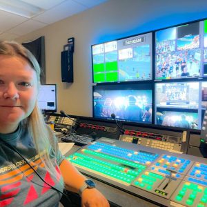 Megan Rakoczy in the control room for media coverage for the Bolder Boulder 10k, directing camera for broadcast