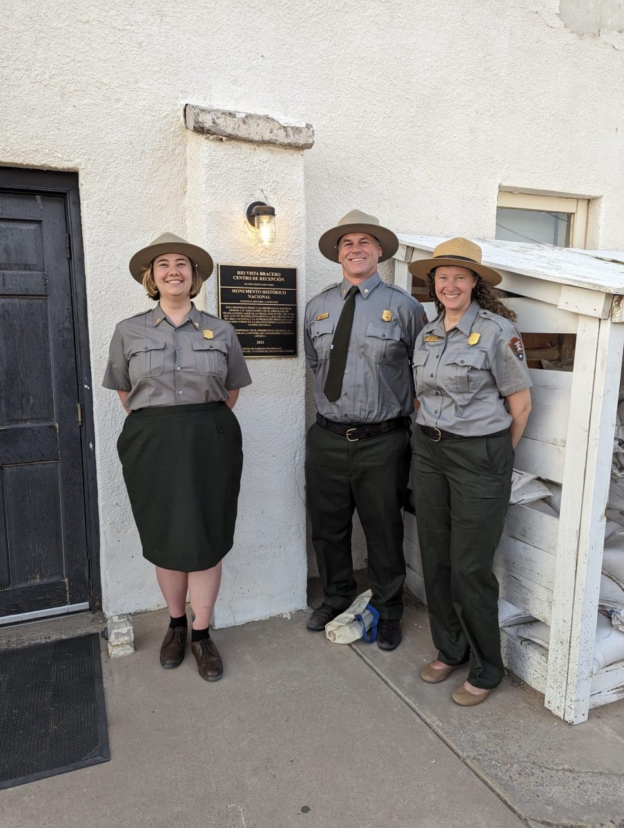 Poppie Gullett dressed in park ranger attire with two colleagues