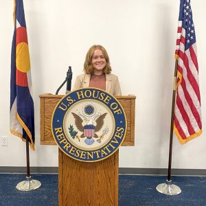 Rachel Pratt at a lectern for Congressman Neguse