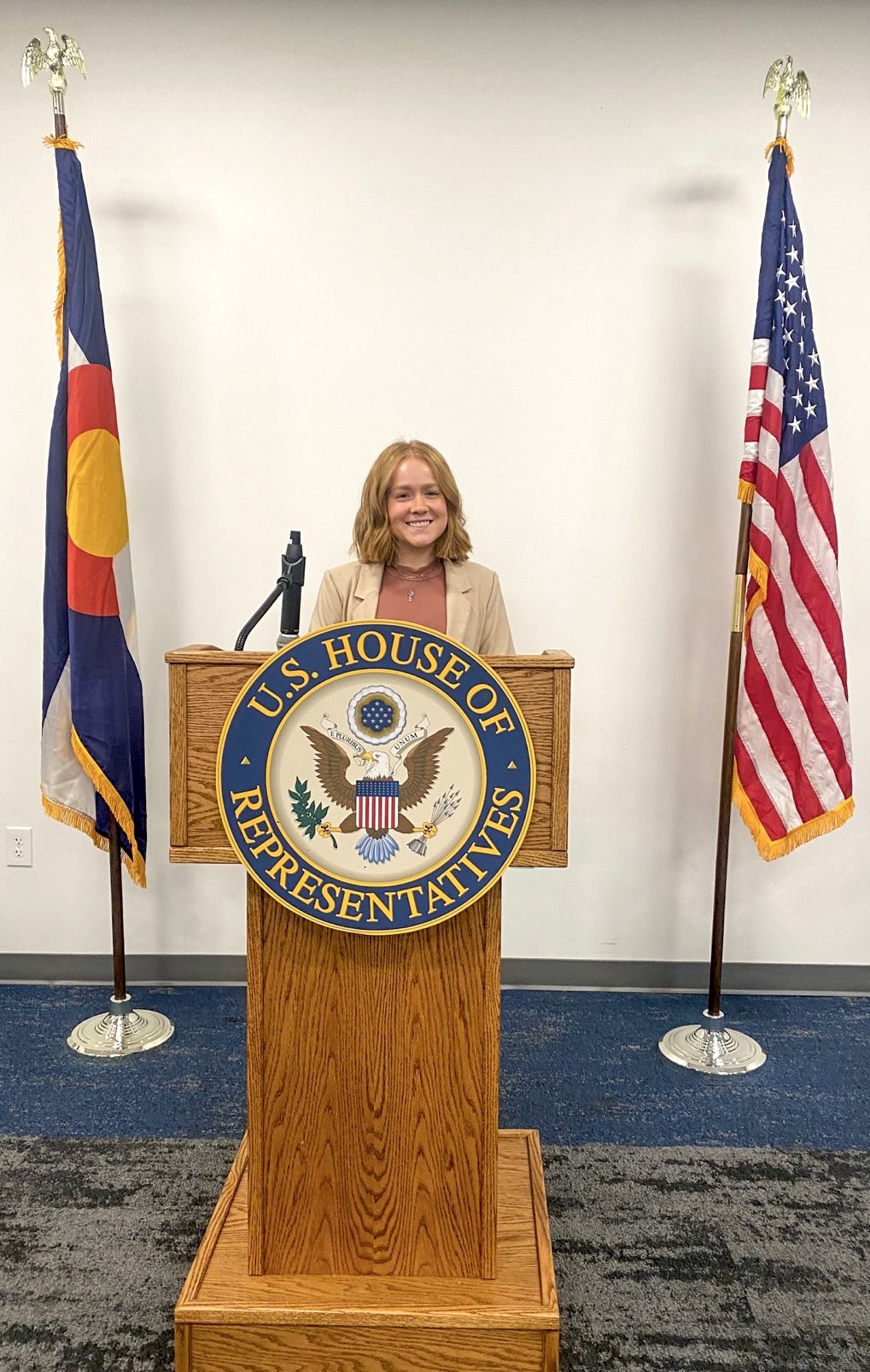 Rachel Pratt at a lectern for Congressman Neguse