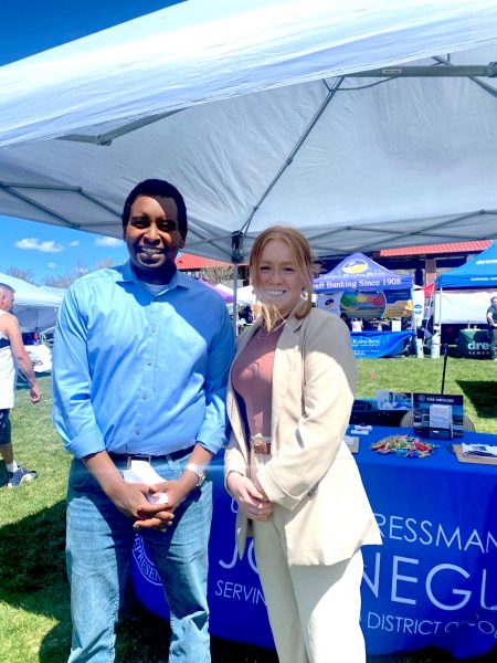 Joe Neguse and Rachel Pratt tabling at a community event