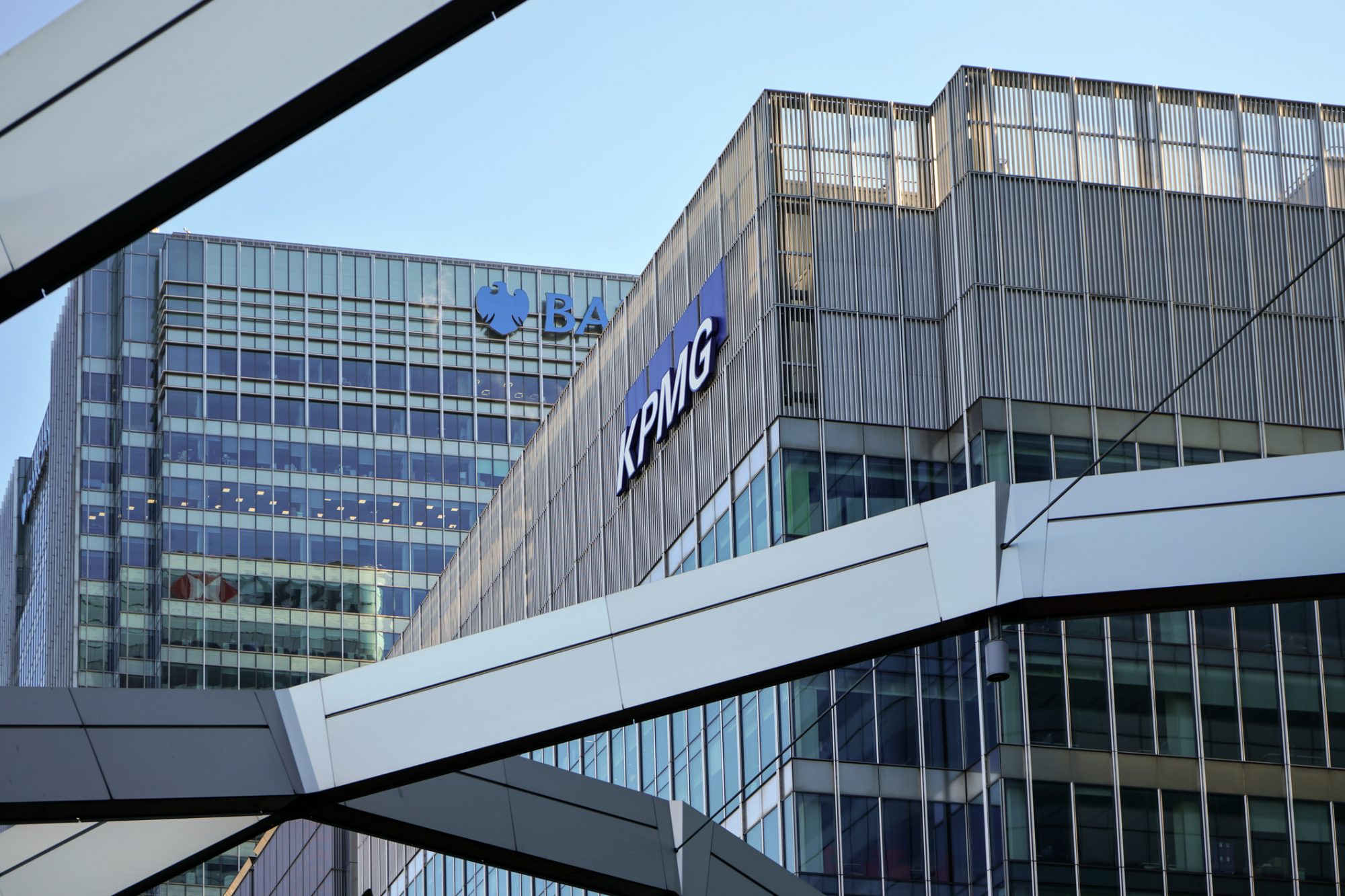 Blue KPMG signage at their offices on 15 Canada Square in Canary Wharf - headquarters of company in the UK. It's one of big 4 accounting firms