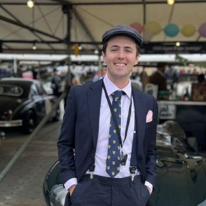 Justin Smith poses in front of an English car at a festival in West Sussex, England