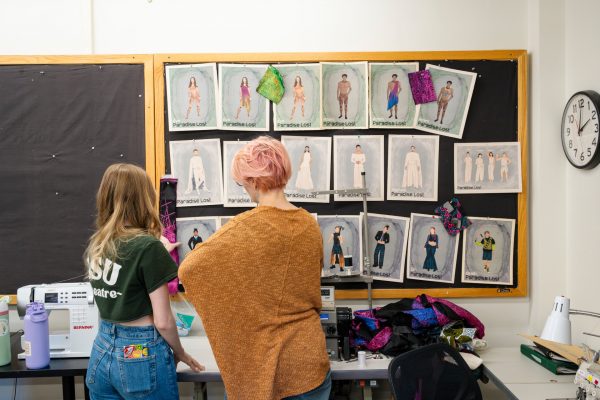 Students in CSU Theatre look at costume sketches in the costume shop on the CSU campus