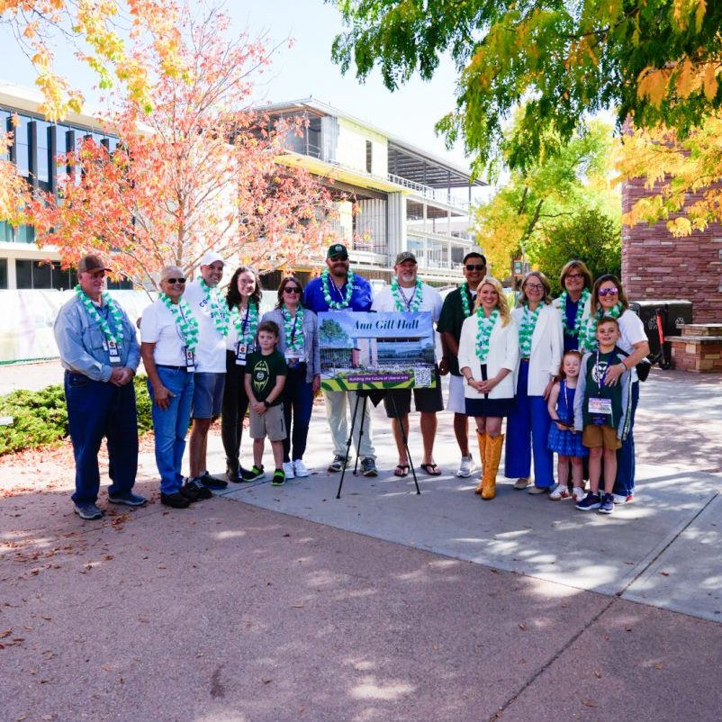 A sign on an easel with the text "Ann Gill Hall" at a naming ceremony outside of the newly revitalized Clark Building.