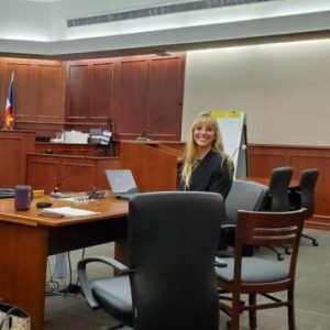 Leslie smiling in a courtroom