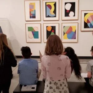 Elementary school students viewing art at the Gregory Allicar Museum of Art as part of the BRAINY (Bringing Arts Integration to Youth) program.